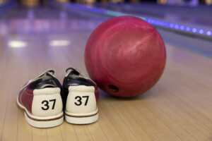 Bowling ball and bowling shoes placed on a lane at Rumble Zone, showcasing the best bowling experience in Gurgaon for friends and families.
