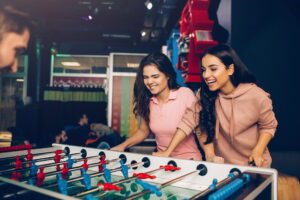 gaming zone in gurgaon friends playing table foosball game at rumble zone