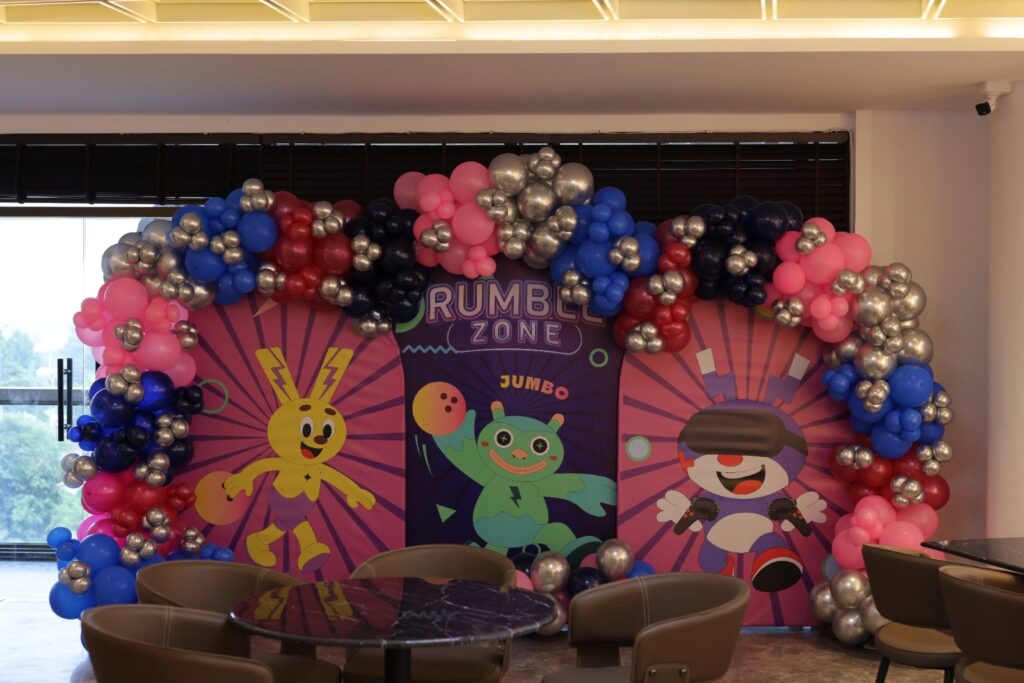 Birthday party hall for kids in Gurgaon with colorful balloon arch and cartoon-themed backdrop at Rumble Zone