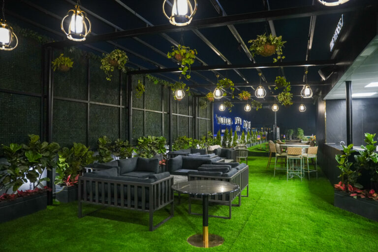 rooftop cafe on Golf Course Extension Road with lounge seating, greenery, and ambient lighting at Rumble Zone Gurgaon