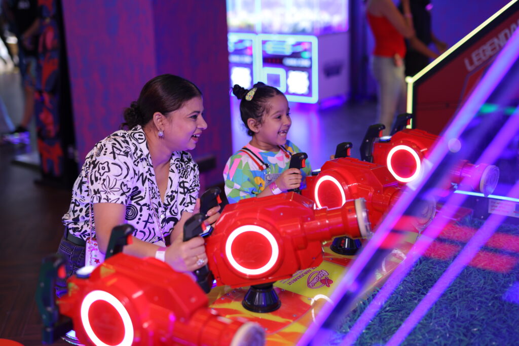 mother and child enjoying arcade games at a gaming zone in gurgaon